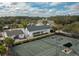 An aerial view of a tennis court next to a pool and clubhouse at 4780 Majestic Hills Loop, Brooksville, FL 34601
