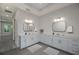 Double vanity bathroom with modern fixtures and a large mirror at 4780 Majestic Hills Loop, Brooksville, FL 34601