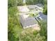 New construction home with gray roof, nestled in a wooded neighborhood at 4780 Majestic Hills Loop, Brooksville, FL 34601