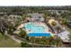 Aerial view of community pool, clubhouse, and surrounding landscape at 4780 Majestic Hills Loop, Brooksville, FL 34601