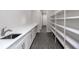 White cabinets, quartz countertops, and ample shelving in this butlers pantry at 4780 Majestic Hills Loop, Brooksville, FL 34601