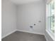 Laundry room with gray tile floor and a large window at 4780 Majestic Hills Loop, Brooksville, FL 34601