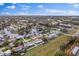 Scenic aerial view of waterfront homes, lush greenery, and glistening canals under a sunny, partly cloudy sky at 170 98Th N Ave, St Petersburg, FL 33702