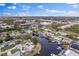 High angle view of single Gathering houses along winding canals under a sunny blue sky dotted with fluffy white clouds at 170 98Th N Ave, St Petersburg, FL 33702