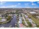 Scenic aerial view of canal-front houses under a sunny blue sky and dotted with fluffy white clouds at 170 98Th N Ave, St Petersburg, FL 33702