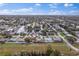 Expansive aerial shot showcases waterfront homes and their pools nestled among lush trees and winding canals at 170 98Th N Ave, St Petersburg, FL 33702