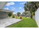 A waterfront backyard with a dock is overlooked by a covered patio at 170 98Th N Ave, St Petersburg, FL 33702