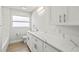 Bathroom vanity with sleek white marble counters and ample storage space at 170 98Th N Ave, St Petersburg, FL 33702