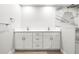 Bathroom featuring double sinks, white cabinets, quartz countertops, and a tiled shower at 170 98Th N Ave, St Petersburg, FL 33702