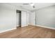Bright bedroom with hardwood floors, large window, closet, ceiling fan, and neutral paint at 170 98Th N Ave, St Petersburg, FL 33702