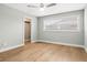 Bright bedroom with hardwood floors, closet, large window, ceiling fan, and neutral paint at 170 98Th N Ave, St Petersburg, FL 33702