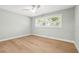 Bright bedroom with hardwood floors, large window, ceiling fan, and neutral paint at 170 98Th N Ave, St Petersburg, FL 33702