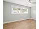 Bright bedroom with hardwood floors, large window, ceiling fan, and neutral paint at 170 98Th N Ave, St Petersburg, FL 33702