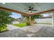 Spacious covered patio with ceiling fan offers stunning waterfront views and features stone pavers at 170 98Th N Ave, St Petersburg, FL 33702