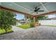A large, covered patio features views of a waterfront backyard and a dock at 170 98Th N Ave, St Petersburg, FL 33702