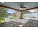 Spacious covered patio has screens and a ceiling fan offering beautiful views of the canal at 170 98Th N Ave, St Petersburg, FL 33702