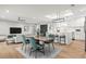 Open concept design with dining area featuring stylish table, chairs, and kitchen with a large center island at 170 98Th N Ave, St Petersburg, FL 33702