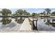A spacious wooden dock overlooks the waterfront canal at 170 98Th N Ave, St Petersburg, FL 33702
