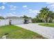 Paver driveway leads up to well maintained home with mature landscaping at 170 98Th N Ave, St Petersburg, FL 33702