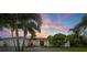 Exterior view of home featuring lush landscaping, decorative driveway, and two-car garage at 170 98Th N Ave, St Petersburg, FL 33702