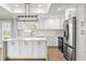 Modern kitchen featuring stainless steel appliances, quartz countertops, and ample cabinet space at 170 98Th N Ave, St Petersburg, FL 33702