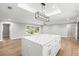 Spacious kitchen island with white marble countertop and stylish pendant lighting at 170 98Th N Ave, St Petersburg, FL 33702