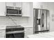 Close up of modern kitchen with stainless steel refrigerator and microwave at 170 98Th N Ave, St Petersburg, FL 33702
