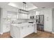 Beautiful kitchen with stainless steel appliances, modern lighting, and quartz countertops at 170 98Th N Ave, St Petersburg, FL 33702