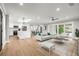 Bright open living space featuring modern furnishings, white kitchen, and sliding glass doors to the outdoor area at 170 98Th N Ave, St Petersburg, FL 33702