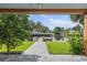A lovely patio view framed by wooden beams overlooks the canal and private dock at 170 98Th N Ave, St Petersburg, FL 33702