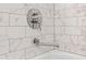 Close-up of a stylish chrome shower fixture with marble tile background at 170 98Th N Ave, St Petersburg, FL 33702