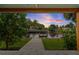 A beautiful view of a canal and dock through the covered patio area at 170 98Th N Ave, St Petersburg, FL 33702