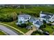 Aerial view of a custom home in a coastal community with lush landscape at 2093 N Pointe Alexis Dr, Tarpon Springs, FL 34689