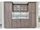 Wet bar with custom cabinetry, marble backsplash, and ample storage at 2093 N Pointe Alexis Dr, Tarpon Springs, FL 34689