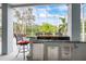 Spacious bar with modern grill, fridge, and lush tropical views, excellent for entertaining at 2093 N Pointe Alexis Dr, Tarpon Springs, FL 34689