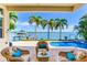 Relaxing patio overlooking a pool and waterfront with boat dock at 17371 Kennedy Dr, North Redington Beach, FL 33708