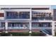 Multi-story home featuring multiple balconies with glass railings, and a staircase leading to the ground level at 1761 Oceanview Dr, St Petersburg, FL 33715