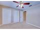 Bedroom with double door closets and ceiling fan at 2020 Lakeview Dr # 203, Clearwater, FL 33763