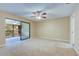 Living room with access to a private balcony and carpeted floors at 2020 Lakeview Dr # 203, Clearwater, FL 33763