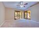 Bright living room featuring sliding glass doors and a ceiling fan at 2020 Lakeview Dr # 203, Clearwater, FL 33763