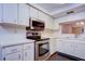 Well-equipped kitchen featuring stainless steel appliances and white cabinets at 2020 Lakeview Dr # 203, Clearwater, FL 33763