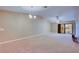 Spacious living room with carpeting and sliding glass doors at 2020 Lakeview Dr # 203, Clearwater, FL 33763