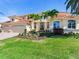Two-story house with three-car garage, palm trees and manicured lawn at 17371 Kennedy Dr, North Redington Beach, FL 33708