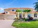 Grand two-story home with tile roof, three-car garage, and lush landscaping at 17371 Kennedy Dr, North Redington Beach, FL 33708