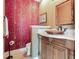 Powder room with copper sink and bamboo-print wallpaper at 17371 Kennedy Dr, North Redington Beach, FL 33708
