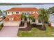 Waterfront home with tile roof, three-car garage, and expansive landscaping at 17371 Kennedy Dr, North Redington Beach, FL 33708