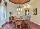 Bright dining room featuring a round table, hardwood floors, and a built-in buffet at 17371 Kennedy Dr, North Redington Beach, FL 33708