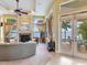 Relaxing living room with fireplace, water views, and access to pool area at 17371 Kennedy Dr, North Redington Beach, FL 33708