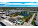 Community aerial featuring a pool, green spaces, tennis court, and serene water features at 6015 19Th N St # 308, St Petersburg, FL 33714