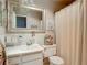 Bright bathroom features a white vanity, subway tile backsplash, and a decorative mirror at 6015 19Th N St # 308, St Petersburg, FL 33714